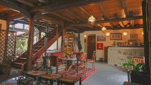 A rustic interior with a wooden staircase, a bar area, and traditional furnishings. - Hagiati Filippos - Edessa Cozy Mountain Retreat (Edessa)