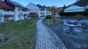 A residential area with houses, a paved pathway, and outdoor seating. - Hotelpark-Bodetal by Interhome (Thale)