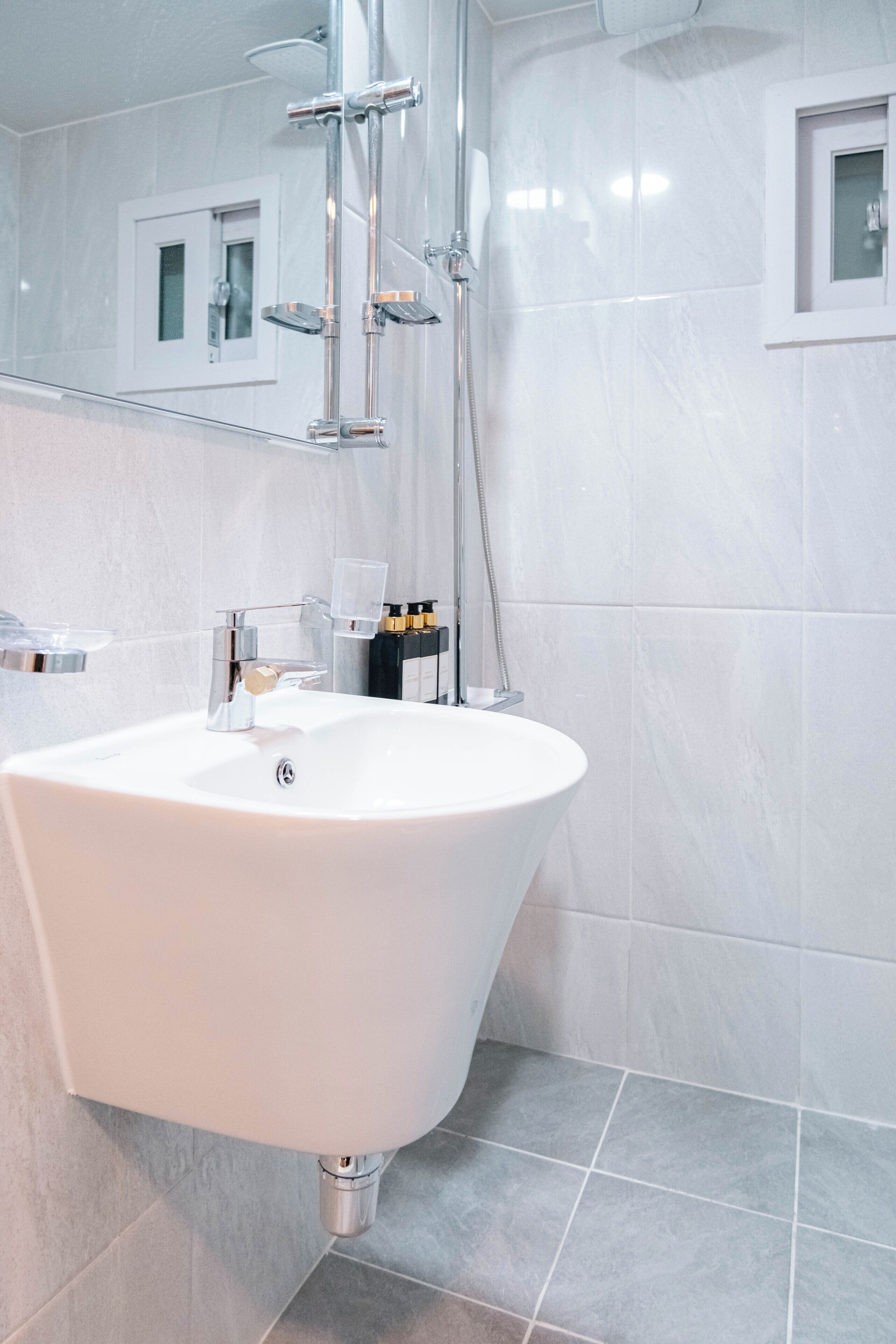 A modern bathroom with a freestanding bathtub, a large sink, and a shower.