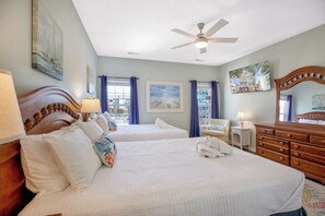 A hotel room with two beds, a ceiling fan, a dresser, and a chair. - Palmetto Breeze Coastal Retreat w Private Pool (Surfside Beach)