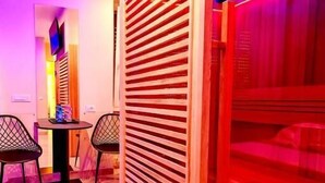A modern interior with a closed sliding door, a dining area with two chairs, and a table with a small decorative item. - Bed Cinecittadue (Rome)