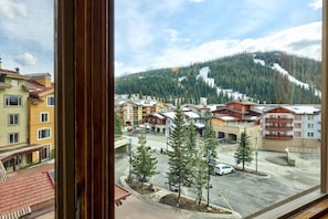 A view of a town with buildings and a mountain in the background.