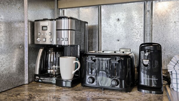 A kitchen with a coffee maker, toaster, and a coffee pot. - Creekbend 3 Bedroom Home (Sevierville)