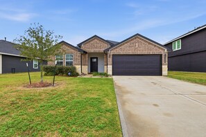 A residential house with a brick facade, a front garage, and a well-maintained lawn. - Sunset Creek Sanctuary - Spacious Family Home 3 Bedroom Home (Richmond)