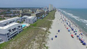 A coastal hotel with multiple buildings, a sandy beach, and a view of the ocean. - Sea Cloisters 101e 3 Bedroom Condo (North Myrtle Beach)