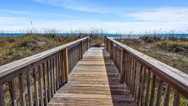A wooden boardwalk leading to a beach with a clear sky. - Sea Cloisters 101e 3 Bedroom Condo (North Myrtle Beach)
