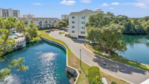A residential area with a curved road, a swimming pool, and a large building with a dome roof. - Ocean Keyes 2445 3 Bedroom Condo (North Myrtle Beach)