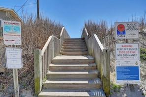 A wooden staircase leading to a beach area with multiple informational signs. - Ocean Breeze: Welcoming Oceanfront House steps away from the beach - 4/BR 3/BA (North Topsail Beach)
