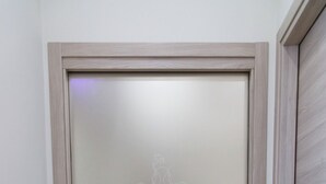 A door with a frosted glass panel, a metallic handle, and a logo with the text 'BEAUTY CHARM'. - park hotel la corte & spa (Palma Campania)