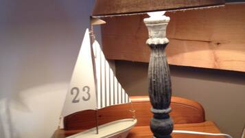 Un modellino di barca a vela con il numero 23 e la scritta "Ocean" su un tavolo di legno.