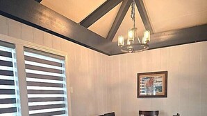 A dining area with a wooden table and chairs, a bench, and a chandelier. - SW-59 Deaver's Delight  Newly remodeled (Beech Mountain)