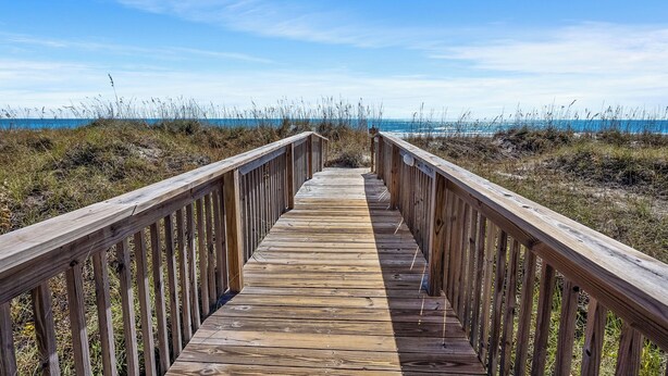 A wooden boardwalk leading to the beach with railings on both sides. - Sea Cloisters II Ocean Front Beach Retreat (North Myrtle Beac)