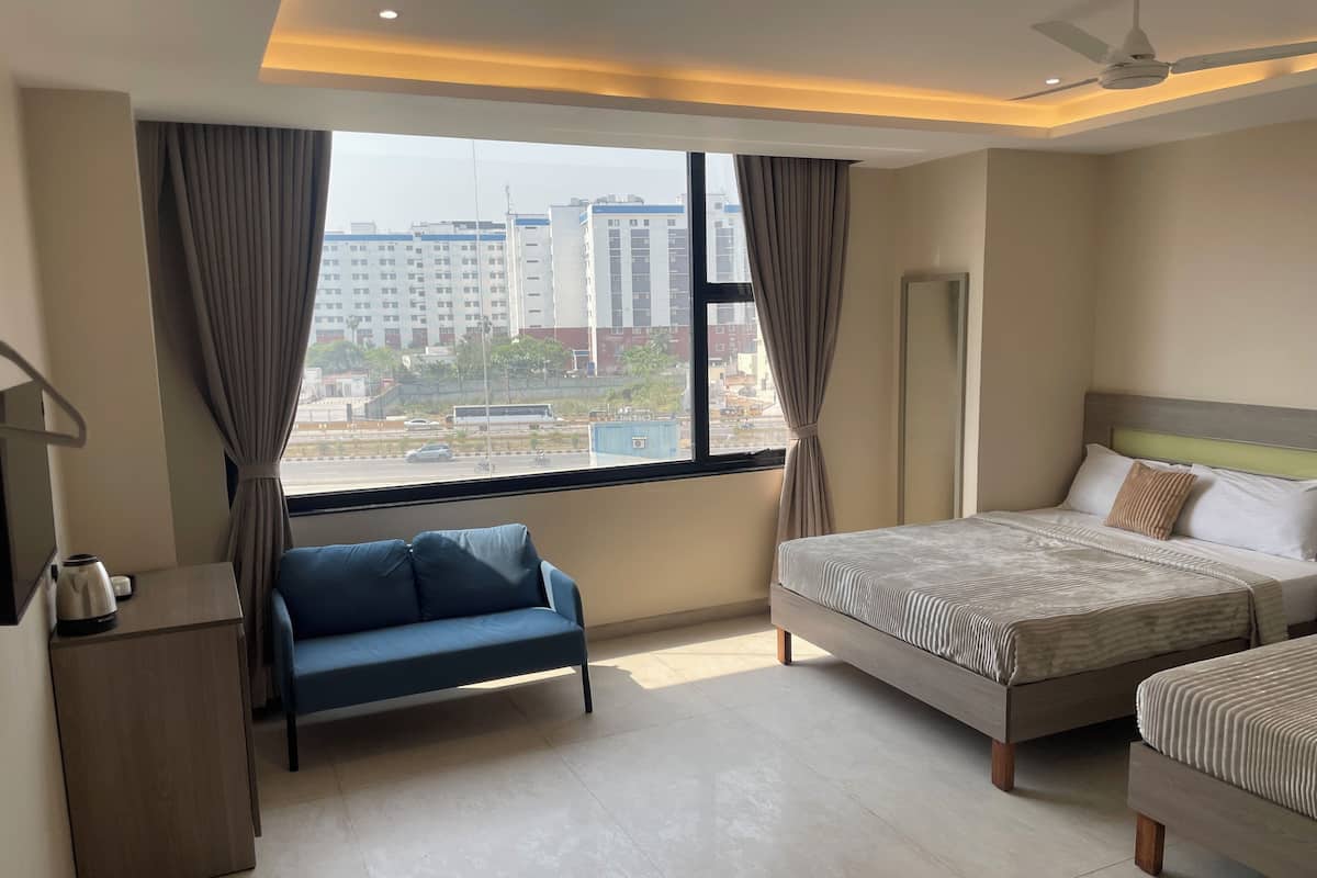 Deluxe Quadruple Room, City View | Desk, laptop workspace, blackout drapes, soundproofing