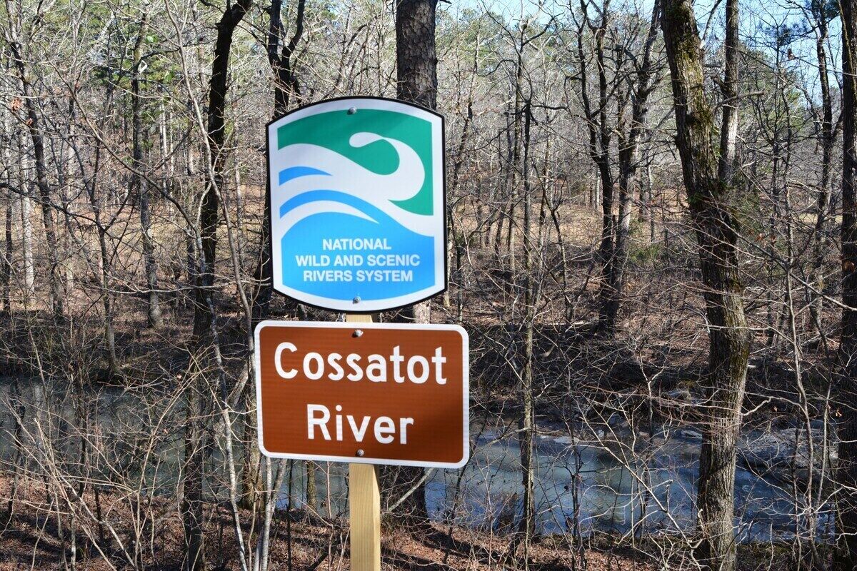 A sign indicating the Cossatot River is part of the National Wild and Scenic Rivers System.