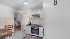 A compact kitchen with a stove, oven, and a small countertop.