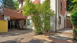 A building with a number '22' sign, a paved entrance, and a small tree in the foreground. - Room '3' with Shared Terrace and Wi-Fi (Baden-Baden)