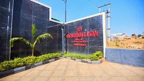 A hotel entrance with a sign reading 'Bourdillon Hotel & Apartments' and a marble facade. - Bourdillon Hotel & Apartments Airport Rd (Abuja)