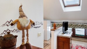 A room with a gnome decoration, a window, and a kitchen area.