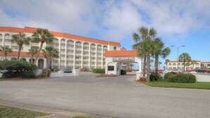 A hotel with a red roof, multiple balconies, and a sign reading "El Matador." - 235 El Matador (Fort Walton Beach)
