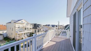 A residential area with a wooden deck and white railings. - 26 N Washington Ave (Ventnor City)