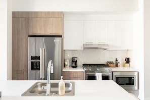 A modern kitchen with stainless steel appliances, a built-in oven, and a coffee maker. - 2880: Relaxed Elegance at Espadin (Denver)