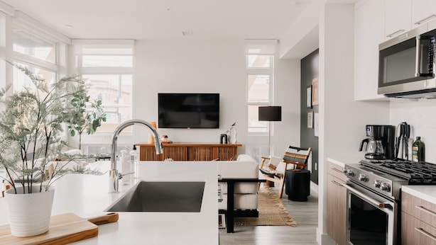 A modern kitchen with a large island, built-in oven, and a flat-screen TV. - 2880: Rhythm of the Night Loft at Espadin (Denver)