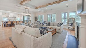 A spacious living area with a sofa, coffee table, and a fireplace. - 2410 The Bent Twig (Seabrook Island)