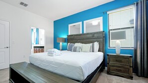 A bedroom with a bed, bedside tables, and a window with curtains. - 2616 Tranquility, Kissimmee, 6 BED (Kissimmee)