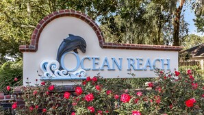 A sign with the text "Ocean Reach" and a dolphin graphic. - 2888 Tidewater Drive (Fernandina Beach)