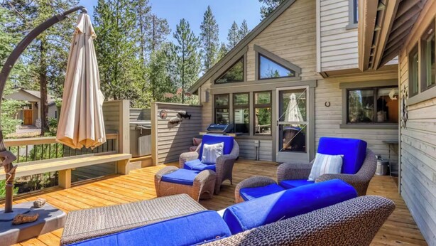 A wooden deck with wicker furniture and a grill area. - 28 Big Leaf (Bend)