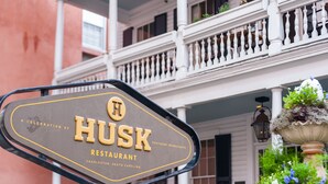 A sign for Husk Restaurant with a classic design, located in Charleston, South Carolina. - 2942 Atrium Villa (Seabrook Island)
