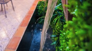 A restaurant patio with outdoor seating, a water feature, and hanging lights. - Cozy 1-Bedroom Studio with AC in beautiful Chefchaouen (Chefchaouen)