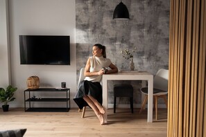 Suite estudio Deluxe, Aire acondicionado | Zona de estar | Una televisión de pantalla plana