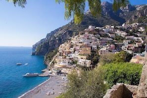 A coastal town with buildings built on a hillside overlooking the sea. - Casa Lalen,
Luxury Apartment with Jacuzzi and Terrace in the Heart of Sorrento. (Sorrento)