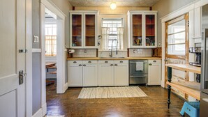 A kitchen with white cabinets, a wooden countertop, and a built-in dishwasher. - 1 Mi to Overton Park: Extended Stay in Memphis! (Memphis)