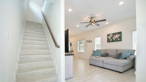 A spacious living area with a staircase, a grey sectional sofa, and a ceiling fan. - Private Townhouse: Close to Everything (San Antonio)