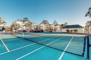A tennis court with a net in the middle, surrounded by a fence. - 2 BR Condo w/ Shared Pool, Near Outlet Mall (Myrtle Beach)