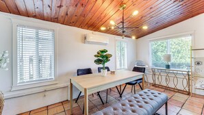 A dining area with a wooden table, chairs, a bench, and a ceiling with exposed beams and lights. - 5 Mi to Las Olas Beach! Bright Home w/ Fenced Yard (Fort Lauderdale)
