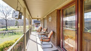 A covered porch with outdoor seating, a brick wall, and a large glass door. - 3 Mi to Ruby Falls: 'the Downer House' w/ Yard (Chattanooga)
