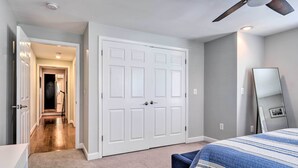 A bedroom with a large bed, a wardrobe, and a ceiling fan. - Old Town Walkable Paradise w/ Private Patio! (Alexandria)