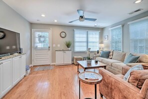 A living room with a sofa, coffee table, and a television. - Old Town Walkable Paradise w/ Private Patio! (Alexandria)