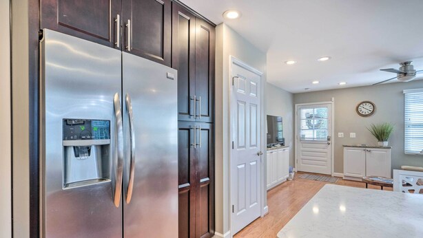 A modern kitchen with stainless steel appliances, white cabinetry, and a marble countertop. - Old Town Walkable Paradise w/ Private Patio! (Alexandria)