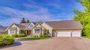 A two-story house with a garage, a driveway, and well-maintained landscaping. - Waterfront Alexandria Gem: Family & Group Friendly (Alexandria)