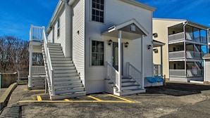 A two-story building with a porch and a staircase leading to the entrance. - Apt. Walking Distance to OOB Pier & Saco Bay! (Old Orchard Beach)