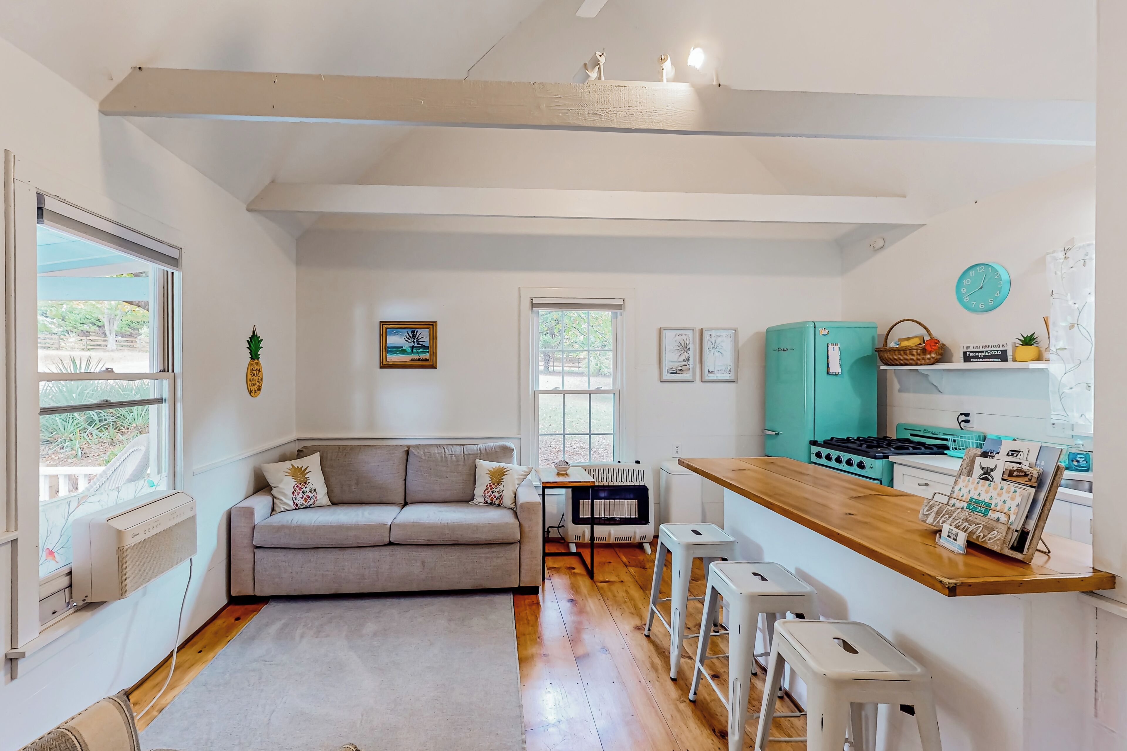 A compact living space with a kitchenette, a sofa, and a dining area.