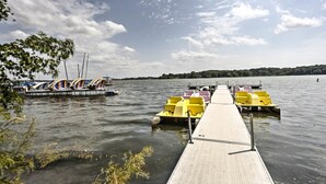 A wooden pier extending into a lake with yellow paddle boats docked at the end. - Plymouth House: Walk to Beach & Medicine Lake! (Plymouth)