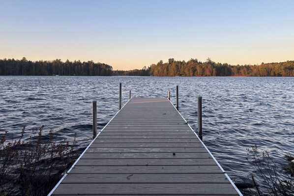A wooden pier extending into calm water, surrounded by trees. - Private Peninsula! Laurel Lake Retreat w/ 3 Piers (Three Lakes)