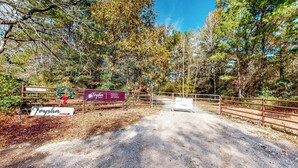 A gravel path leading to a gated area with signs indicating 'Toyha' and 'Toysha'. - Private Pool! Nat'l Forest Retreat on 1 Acre (Oakhurst)