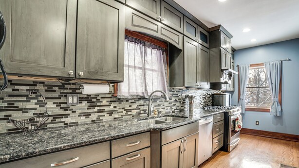 A kitchen with granite countertops, stainless steel appliances, and wooden cabinets. - Private Hot Tub & Patio! Chicagoland Extended Stay (Lansing)