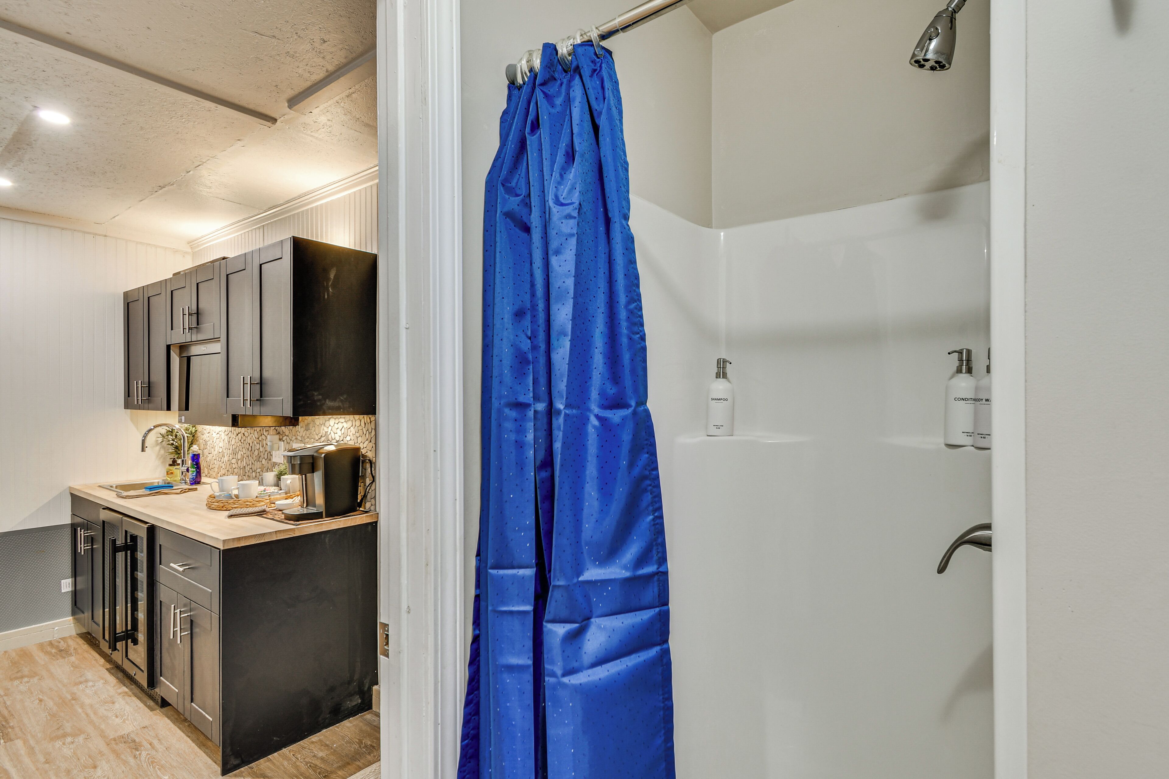 A modern bathroom with a shower, a toilet, and a sink.